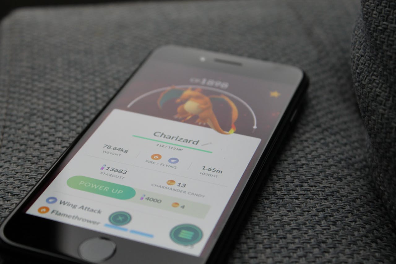 Services Smartphone displaying Pokémon GO screen with Charizard, highlighting gaming technology.